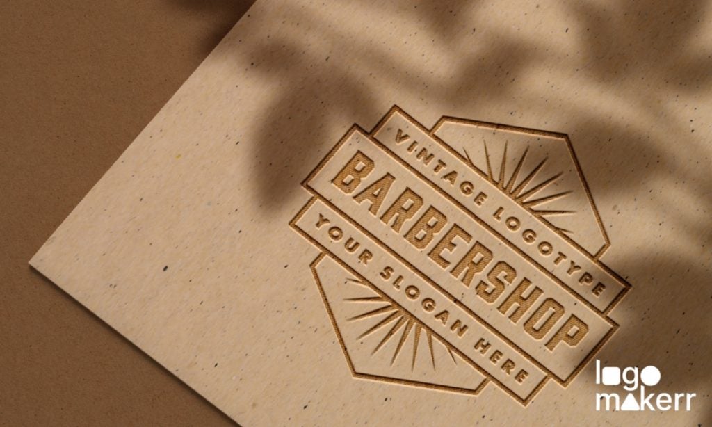 A logo design of a barbershop engraved on a wooden surface over a brown background.