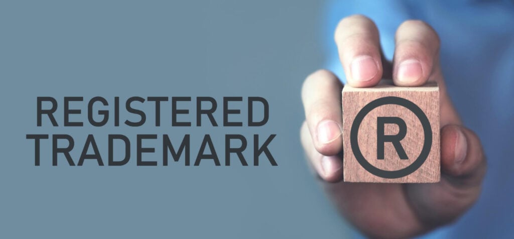 registered trademark on a logo, stamp from a man's hand