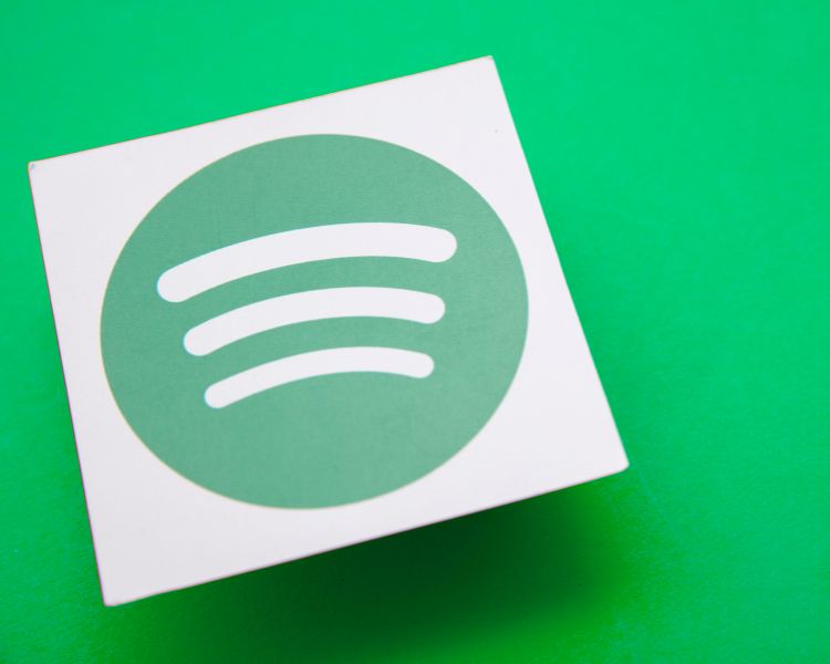 spotify logo design printed on a white paper with green background