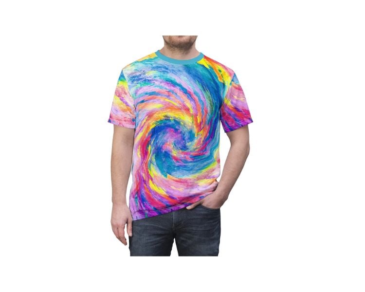 A bearded male clothing model is wearing a t-shirt with a tie-die design.
