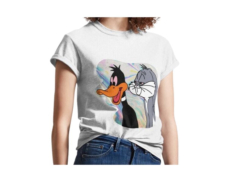 A female clothing model with brown curly hair is wearing a white shirt with a Trippy Cartoon design.