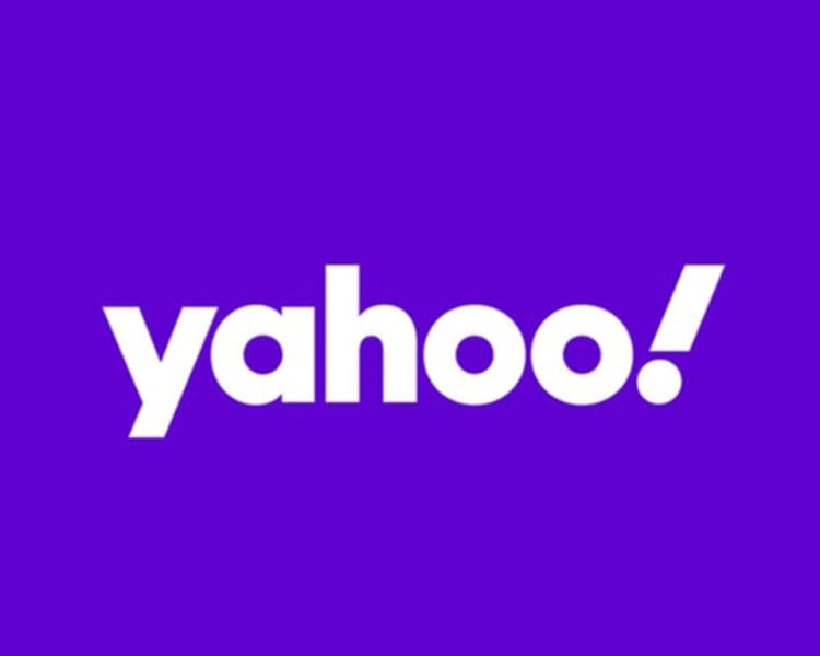 The official logo design of the American multinational technology company Yahoo! Inc. against purple background.