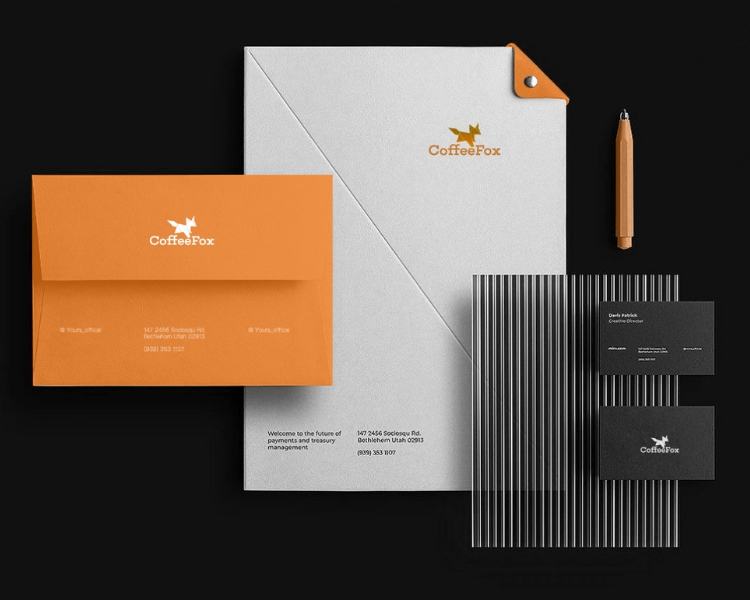 sample mockup for the brand - coffee fox, printed in a folder, envelope, contact card all in black background