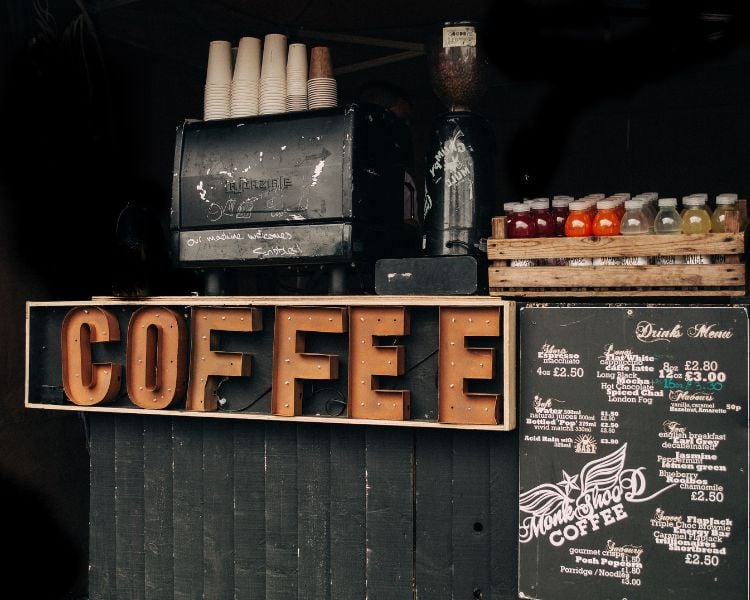 Photo of a small coffee shop with chalkboard on the side