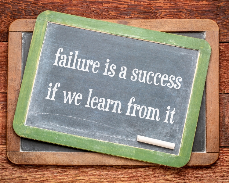 failure is a success if we learn from it written on a small blackboard