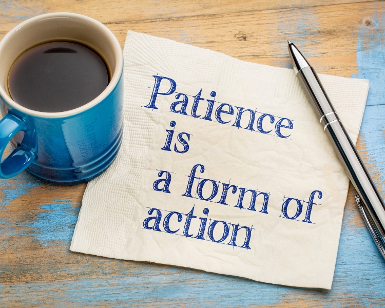 patience is a form of action written on a paper with cup of coffee and a pen on the sides