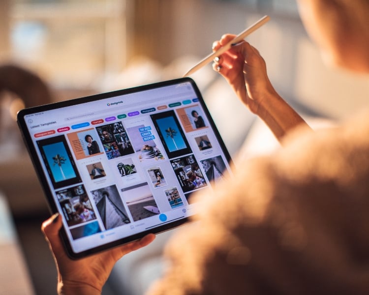 person holding a tablet wtih different design within the monitor