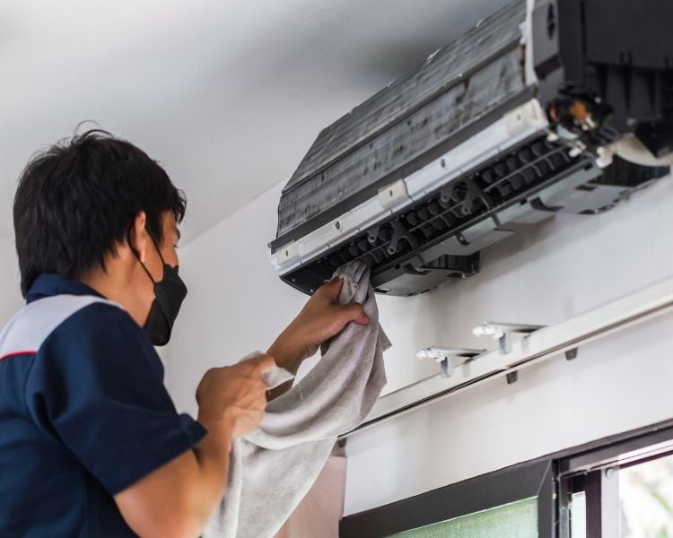 HVAC servicing company with a man and raw aircon unit