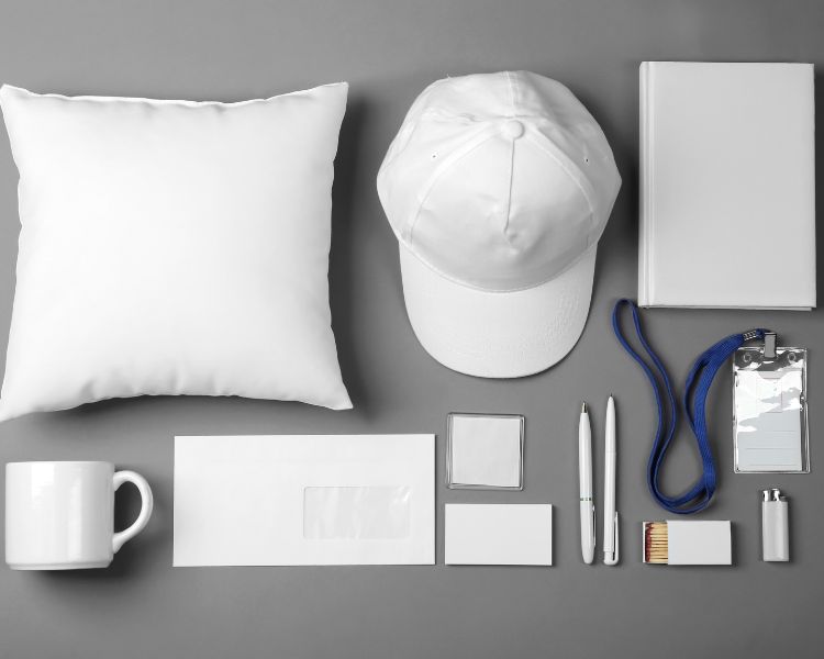 Picture of merchandise like pillow, cap, mugs, notebook, and pens with no brand at all