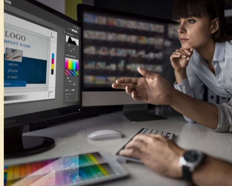 a woman staring at a computer for a comprehensive logo designing process