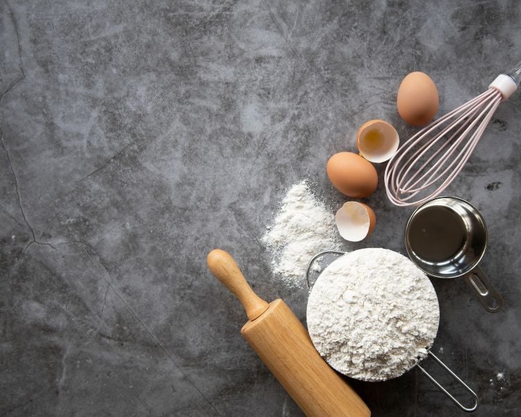 baking tools like whisk, pin, flour, to symbolize the blog making bakery logo